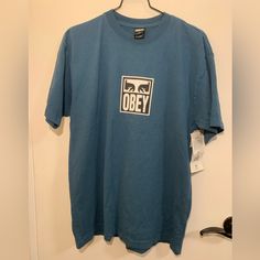 Obey Short Sleeve T-Shirt. 100% Cotton. Color: Blue / Teal. Unisex. Street Wear, Skater. Blue Graphic Tee With Screen Print, Blue Short Sleeve Shirt With Screen Print, Preppy Logo, Painted Shorts, Black Shorts Men, Obey Clothing, Pullover Shirt, Blue Teal, Grey Shorts