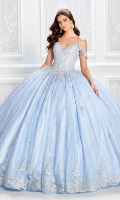 a woman in a blue ball gown posing for the camera