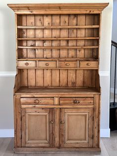 an old wooden bookcase with drawers and cupboards