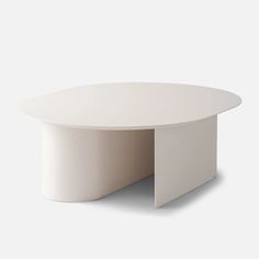 a white table with an oval shaped top