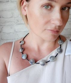 Choker necklace with large (12 mm) round gray-blue ceramic beads. Ceramic beads in a necklace are round, disc-shaped, embossed. Quite heavy and fit well on the décolleté. Choker necklace with ceramic beads and PVC cord is very pleasant to the touch. Large beads are complemented by small beads of faceted hematite. Necklace on a semi-rigid basis, keeps its shape well. Carabiner clasp All decorations are packed in a craft gift box, they will be a great gift for an anniversary, birthday or any other holiday. CARE 1. Try not to drop it so that the ceramic beads do not break 2. Keep away from fire and do not leave in direct sunlight for a long time Unique Choker Necklaces, Large Bead Necklace, Large Beads, Hematite Necklace, Black Choker Necklace, Ceramic Necklace, Small Beads, Chunky Beads, Modern Necklaces