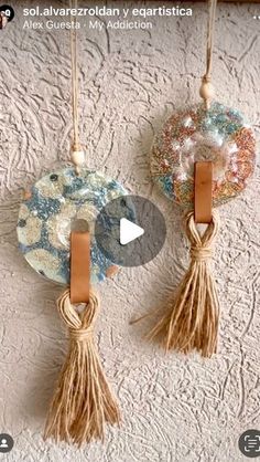 two decorative wall hangings with tassels attached to them