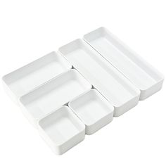 six white dishes stacked on top of each other in the shape of rectangles