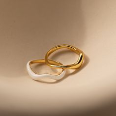 Our Duo Wave Ring Set gives you the perfect combination of minimalist and groovy. The wavy and unique design of these rings are easy to pair with other jewelry pieces in your collection. Add them to your everyday lineup to add dimension while not compromising the effortlessness of your look. Material: High Quality Solid 925 Sterling Silver Finish: 18K Gold ∙ White Enamel Featuring a Set of 2 Wavy Rings: Each with band widths ranging from ~1.5mm to ~3.5mm Model showcases a unique, groovy look fea Cool Ring Designs, Maison Miru, Caitlyn Minimalist, Wave Wedding Band, Wavy Ring, Initial Tag Necklace, Dainty Initial Necklace, Stacking Ring Set, Wave Ring