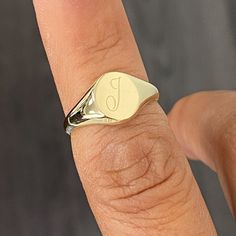 This classic shaped signet style ring is composed of 14K solid gold & can be finished with a raised cameo style engraving of any initial letter desired or a traditional style engraving with any initials or words you would like. Either way, with or without engraving this ring will be a great addition to your collection. NOTE: Please indicate the specific font style desired in the "Notes" section upon checkout. Ring Dimensions: Flat Surface: approximately 8mm (w) x 9.75mm (h) Signet Surface Height Minimalist Monogram Initial Ring, Modern Personalized 14k Gold Engraved Ring, Personalized Initial Ring In 14k Gold With Round Band, Personalized 14k Gold Initial Ring With Round Band, Minimalist Engraved Ring With Initials, Customizable Engraved Round Ring For Everyday, Personalized Modern Engraved Yellow Gold Ring, Minimalist Rounded Signet Ring As Gift, Minimalist Rounded Signet Ring For Gift