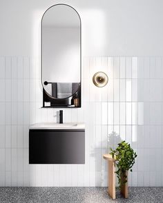 an image of a bathroom with white tile and black fixtures on the wall, along with a mirror