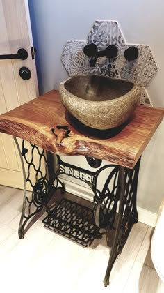 an old fashioned sewing machine with a bowl on top