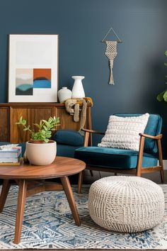 a living room with blue walls and furniture in the corner, including a coffee table