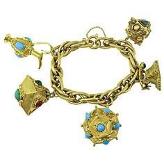 This is a fabulous 18k yellow gold charm bracelet. The bracelet features 5 pieces novelty charms in 18k yellow gold which are 3 lanterns, vintage phone and vintage pitcher. The charms are adorned with semi precious stone which are turquoise, malachite, jade and garnet. The bracelet measures 7 3/4 inches in length and weighs 76.7 grams. Inventory #91703WEBS Telephone Vintage, Vintage Phone, Vintage Phones, Vintage Pitchers, Gold Charm Bracelet, Semi Precious Stone, Gold Charm, Charm Bracelets, Estate Jewelry