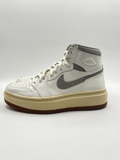 Elevate your sneaker game with these Nike Women's Air Jordan 1 SE Lifestyle shoes. The high-top, white leather design with gray accents is perfect for any athletic or casual occasion. The unique DZ3744-100 style code adds a touch of exclusivity to your wardrobe. With a size 8.5, these sneakers are perfect for any woman looking to add a stylish touch to her outfit. The Air Jordan 1 model is a timeless classic, and the Nike brand ensures top-notch quality. Don't miss out on the chance to own these Nike High Tops, Lifestyle Shoes, Womens Air Jordans, Nike Brand, Woman Looking, Sneaker Games, Air Jordan 1, Leather Design, Stylish Sneakers