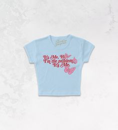 It's Me, Hi, I'm The Problem It's Me with our Taylor Swift inspired 70's retro baby tshirt!- Features lyrics from the song "Anti Hero" with butterflies around it all in light pink and deep red or blue and orange ink- Screen print transfer that is heat pressed onto each tshirt- Tshirt is a super soft, 90s style micro ribbed baby tee- Regular Baby Tee Fit - Cotton / Poly**due to screens & filters color may vary from pictures** Ours Taylor Swift, Taylor Swift Inspired, 90s Sports, Screen Print Transfer, Anti Hero, Retro Baby, Print Transfer, Baby Tees, Western Chic