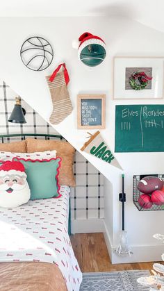 a bedroom decorated for christmas with decorations on the wall and pictures hanging above the bed