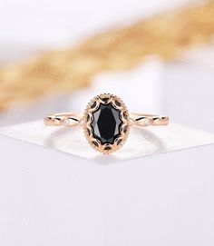 a black diamond ring sitting on top of a white napkin