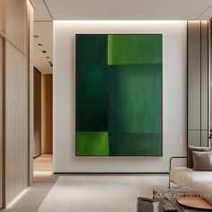 a living room filled with furniture and a large green painting on the wall above it