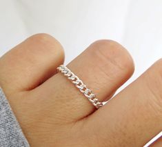 Bold and beautiful. This flexible curb chain ring is handcrafted with high-quality sterling silver material and made to order just for you. Can be worn when washing hands or showering! Wear this chain ring alone or stack it with other rings for a layered looked! Great for gifting. Handmade in Los Angeles, CA! Packaging:  Comes in a gift box, ready for gift-giving! Dimensions: Width: 3mm  Thickness: 0.6mm Material: Sterling Silver / 925 Benefits of Sterling Silver / 925 Jewelry: 1. It's hypoaller Sterling Silver Rings With Silver Chain For Gift, Curb Chain Ring As A Gift, Silver Chain Link Rings Gift, Silver Link Chain Ring As Gift, Adjustable Sterling Silver Chain Ring Gift, Sterling Silver Chain Ring Perfect For Gifts, Silver Sterling Silver Chain Ring Gift, Minimalist Sterling Silver Rings With Silver Chain, Minimalist Sterling Silver Ring With Silver Chain