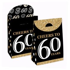 two black and gold 60th birthday bags with the number sixty years printed on each bag