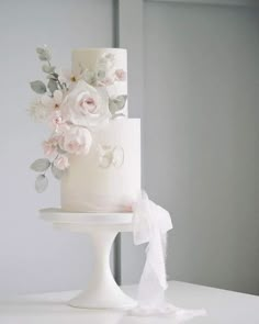 a white wedding cake with flowers on top