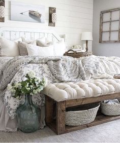 a bed with white sheets and pillows in a room