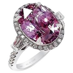 New 18kt White gold custom sapphire ring set with oval cut untreated natural pink sapphire, measuring 12.12 x 9.23 x 5.59 mm with a carat weight of 5.52 ct. Type II, Medium-light, moderately strong, slightly purplish red color GIA slpR 4/4. Set with 38 round brilliant cut diamonds at 0.50 ct's & 4 baguette-cut diamonds at 0.20 cts with a total diamond weight of 0.70 cts. Beautiful light pink sapphire, this rare oval cut sapphire carries a pastel pink hue with excellent tone coupled with smooth s Formal Pink Sapphire Ring In Platinum, Oval Pink Platinum Jewelry, Pink Oval Platinum Jewelry, Classic Pink Sapphire Ring In Platinum, Gia Certified Oval Pink Ruby Ring, Oval Ruby Ring With Brilliant Cut Pink Sapphire, Luxury Pink Oval Sapphire Ring, Formal Oval Pink Sapphire Ring, Oval Brilliant Cut Pink Sapphire Ring