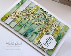 a close up of a card with leaves on it and the words hello written in gold