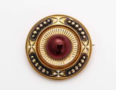 For Sale on 1stDibs - A superb brooch of museum quality is brilliant with a glowing cabochon garnet surrounded by white and gold enamel and a locket in the back. The gold rays Gold Brooch, Gold Brooches, Gold Enamel, White Enamel, Antique Victorian, Locket, Garnet, For Sale, Gold