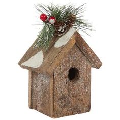 a birdhouse with pine cones and berries on top