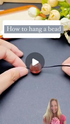 two hands holding a bead with the words how to hang a bead on it