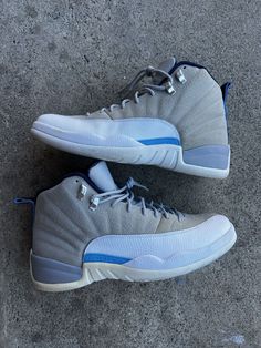 Elevate your sneaker game with these Nike Air Jordan 12 Retro University Blue Wolf Grey sneakers. The mid-top style and standard shoe width make these shoes perfect for any athletic activity, especially basketball. The nubuck upper material and Air Jordan product line ensure top-notch performance and style, while the retro theme and 2016 release year add a touch of nostalgia to your wardrobe. These sneakers are size 12 for men and feature a sleek gray and blue color scheme with the iconic Jordan silhouette. Don't miss out on this must-have addition to your collection.