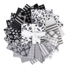 a pile of black and white fabric squares