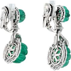 Celebrate the intersection of creativity and class in these exquisite David Webb Platinum Carved Green Emerald And Diamond Drop Earrings. Adorn your ears with the allure of nature's green beauty, embodied in the captivating carved green emeralds that dangle gracefully, accentuated by the brilliance of round-cut diamonds. Each earring is a masterpiece, meticulously crafted in platinum, weighing a luxurious 22.0 grams, ensuring durability and timeless elegance. Designed by the renowned David Webb, these earrings are a testament to his artistic vision and exceptional craftsmanship, making them a coveted addition to any jewelry collection.Indulge in the allure of luxurious green hues and sparkling diamonds, perfect for special occasions or to elevate your everyday style with a touch of sophist Luxury Green Pierced Earrings, Green Luxury Pierced Earrings, Green Luxury Earrings, Luxury Green Oval Earrings, Luxury Green Sterling Silver Diamond Earrings, Luxury Green Diamond Earrings In Sterling Silver, Green Sterling Silver Luxury Diamond Earrings, Green Diamond Pierced Earrings, Luxury Green Clip-on Earrings For Formal Occasions