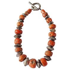 A wonderful example of a Tibetan Coral Bead mala / neckpiece with a stunning mix of orange & red colours that have aged beautifully over the decades. Tibetans believe that coral holds great power for the wearer both spiritually as well as physically. This necklace also features silver painted wooden beads. Dimensions; Length 40cm fully laid out (20cm when worn) x Width 4cm x Depth 2cm Weight: 195 grams. Amber Bead Necklace, Silver Paint, Wire Necklace, Coral Necklace, Amber Beads, Bone Beads, Great Power, Aging Beautifully, Resin Beads