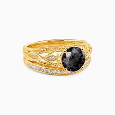 a gold ring with a black stone and diamonds