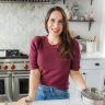 a woman is standing in the kitchen preparing food