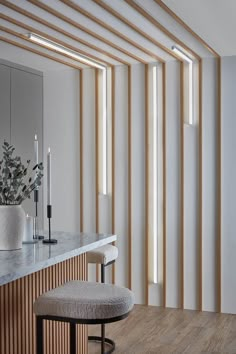 Waterproof individual slats spaced out on a kitchen wall with strip lighting between. Wood Slats Office Wall, Slatwall Bathroom, Wall Panelling With Lights, Wooden Wall Decor Diy, Wood Wall Texture Interior Design, Wood Panelling Walls Hallway, Half Slat Wall, Slat Wall Entryway, Wall Slats Decor