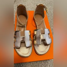 Very Rare Color. Wear Once. Still In Brand New Condition Except For The Bottom Sole Fit Big Since I Am Normally 6,5 Everywhere Else Except For Hermes Shoes/Sandals. Fuzzy Sandals, Hermes Oran Sandals, Rose Gold Sandals, Hermes Shoes, Gold Sandals, Hermes Bags, Taupe Color, Santorini, Brown Gold