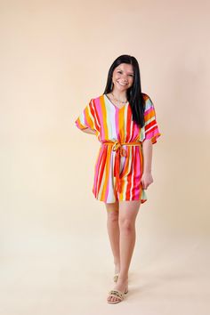 This romper is perfect in the sun and in the shade! It includes a v neckline, short sleeves, an elastic natural waist with an optional tie, and a cute striped print in pink, orange, green, and light blue. Pair this with wedges for a Spring look! Inseam measures 2.5 inches long. Model: Kristen is wearing a size small. Abby is wearing a size large. Maci is wearing a size 2XL. Size Suggestions and Measurements: Small: Bust: 19 inches across the front | Length: 32 inches Medium: Bust: 20 inches acro Striped V-neck Jumpsuits And Rompers For Summer, Casual Multicolor V-neck Jumpsuit, Summer Jumpsuits And Rompers With Tie Waist And V-neck, Short Sleeve Jumpsuits And Rompers For Brunch, Playful Striped Summer Dresses, Multicolor V-neck Jumpsuits And Rompers For Beach, Vacation Summer V-neck Jumpsuits And Rompers, Casual Beach Season Jumpsuits And Rompers With Tie Waist, Summer Brunch Jumpsuits And Rompers With Short Sleeves