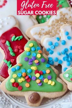 a plate full of decorated cookies with the words gluten free sugar cookies mom's famous cut out recipe