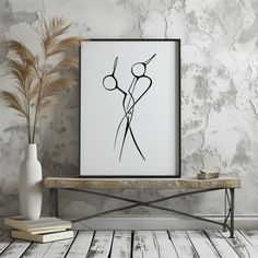 a black and white drawing on a wall next to a vase with some plants in it