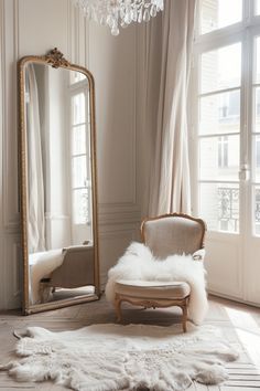 a chair sitting in front of a large mirror on top of a floor next to a window