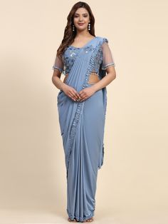 Stitched Saree with blouse in Powder blue colour 102073A A full-stitch drape saree is a contemporary take on the traditional Indian saree, combining the elegance of the drape with the convenience of a pre-stitched garment. This innovative design features a pre-pleated pallu and a stitched skirt, offering ease of wear without compromising on style. Ideal for modern women who appreciate the grace of a saree but seek practicality in their attire, the full-stitch drape saree allows for effortless dr Blue Georgette Pre-draped Saree With Self Design, Festive Blue Art Silk Pre-draped Saree, Semi-stitched Draped Blouse Piece For Eid, Formal Pre-draped Saree For Navratri, Fitted Blue Pre-draped Saree For Festive Occasions, Blue Georgette Pre-draped Saree With Pallu, Blue Fitted Pre-draped Saree For Navratri, Bollywood Style Blue Pre-draped Saree For Eid, Blue Georgette Pre-draped Saree For Formal Occasions