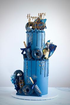 a blue birthday cake with decorations on top