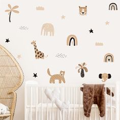 a baby's room with a crib and wall decals