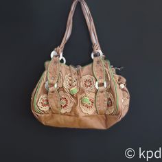 This vintage Jamin Puech leather embroidered handbag is a remarkable piece of fashion artistry that stands out for its unique blend of elegance and playfulness. Made from soft, genuine leather, this handbag is designed to age gracefully, developing a beautiful patina that only authentic leather can achieve. The craftsmanship is evidently meticulous, with the bag adorned in intricate floral embroidery that showcases a range of colorful stitches and textures. The addition of crocheted lace flowers Leather Bag With Floral Embroidery And Rectangular Shape, Rectangular Leather Bag With Floral Embroidery, Vintage Beige Leather Hobo Bag, Embroidered Brown Hobo Shoulder Bag, Embroidered Brown Hobo Bag, Embroidered Brown Hobo Tote Bag, Brown Embroidered Hobo Shoulder Bag, Embroidered Brown Tote Hobo Bag, Vintage Beige Embroidered Shoulder Bag