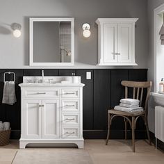 a white bathroom with black and gray walls, wooden floors and furniture in the room