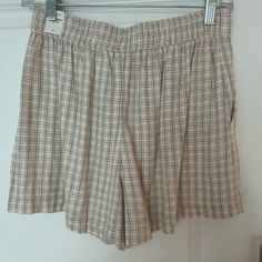 These Linen Pull On Shorts Or Brand New And Waiting To Be Worn. Plaid Coloring Is A Green, Tan, And Light Brown. Cute For Going To The Pool Or Running Errands. Would Look Great With A Body Suit Or Flowy Blouse Summer Beige Shorts With Elastic Waistband, Beige Summer Shorts With Elastic Waistband, Casual Beige Shorts For Day Out, Spring Neutral Shorts With Elastic Waistband, Neutral Shorts With Elastic Waistband For Spring, Neutral Bottoms With Built-in Shorts For Summer, Neutral Shorts With Pockets For Day Out, High-waisted Shorts In Neutral Color For Summer, Neutral Short Bottoms For Summer