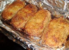 four fried meat patties sitting on top of tin foil