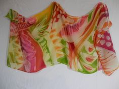 This stunning hand painted silk batik chiffon scarf is a great accent for any spring casual or dressy outfit. I folded the scarf in half before applying French Dyes, and wax resist techniques to create an ethnic abstract design. This scarf has hand rolled hems. This scarf may be dry cleaned or you may hand wash this item in cool water and mild soap. Blot dry in towels and press while still damp. Bohemian Multicolor Silk Sarong, Pink Silk Scarf For Summer Beach, Multicolor Floral Silk Scarf For Beach, Multicolor Floral Print Silk Scarf For Beach, Yellow Bohemian Silk Scarf For Summer, Multicolor Silk Scarf For Beach, Yellow Bohemian Silk Scarf For Spring, Velvet Scarf, Silk Scarf Painting