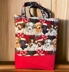 a red and white bag with dogs on it sitting on a wooden table next to a wall