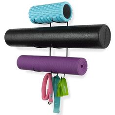 two yoga mats hanging on the wall with handles and straps attached to them, one has a