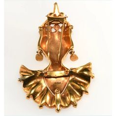 This Reinad Asian Princess fur clip brooch is much more detailed in the design and construction than many others by this company and likely sold at a higher price point when it was new. It has bright, unworn gold plating and rhinestones in two hues of purple along with clear accents. Marked Reinad on the back. Dates to around 1940. Measures about 3 3/4" long and 2 1/2" wide. Condition is excellent with only minor wear to the red paint on the lips. A very dimensional piece of collectible costume jewelry that looks amazing when worn. Gold Art Deco Brooch For Evening, Gold Art Deco Brooches For Evening, Victorian Gold Brooches For Evening, Ornate Gold Brooches For Evening, Gold Brooches With 17 Jewels For Evening, Gold Jeweled Brooches For Formal Occasions, Formal Gold Jeweled Brooches, Victorian Jeweled Gold Brooches, Elegant Gold Jeweled Brooches